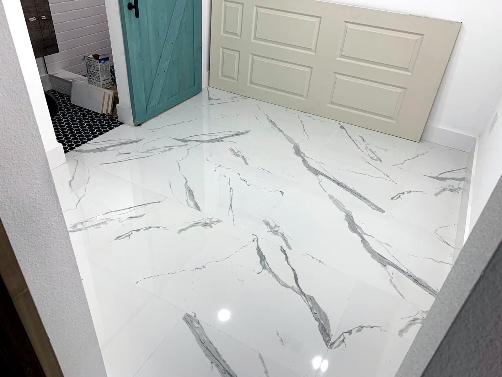 White marble-look bathroom and entry: Marble-look porcelain tile