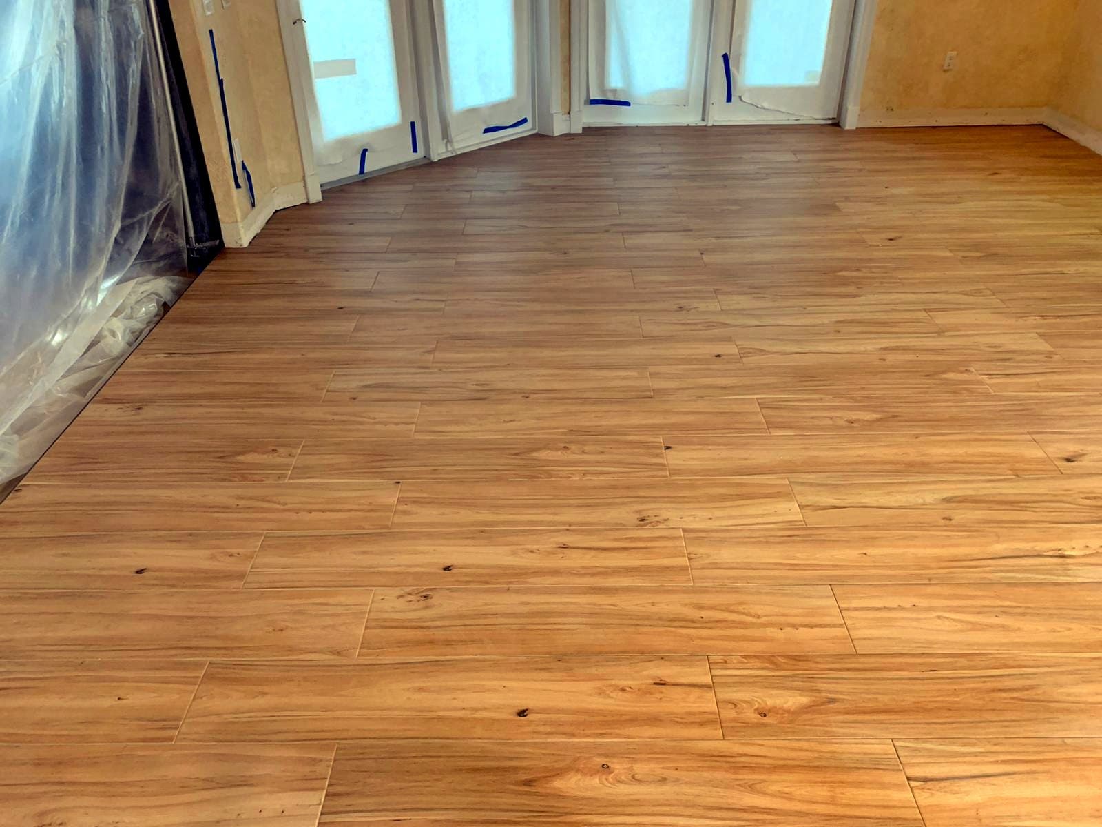 Room with French doors: Wood-look porcelain tile, photo 1