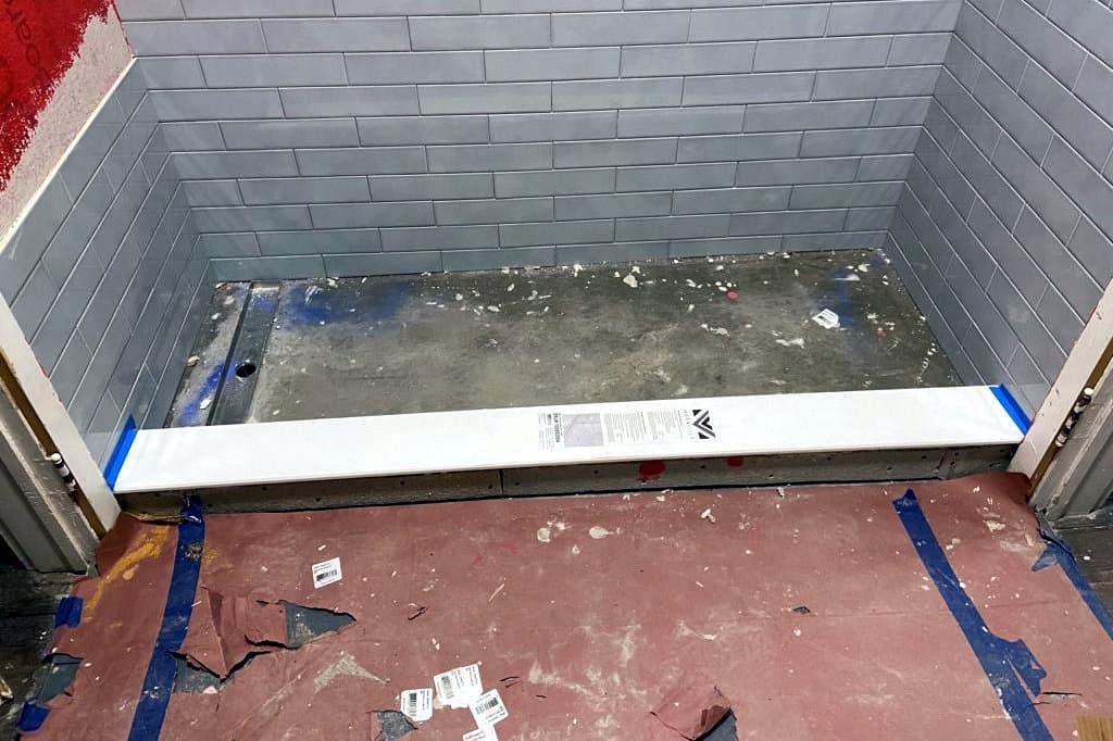 Shower and bathroom floor, before